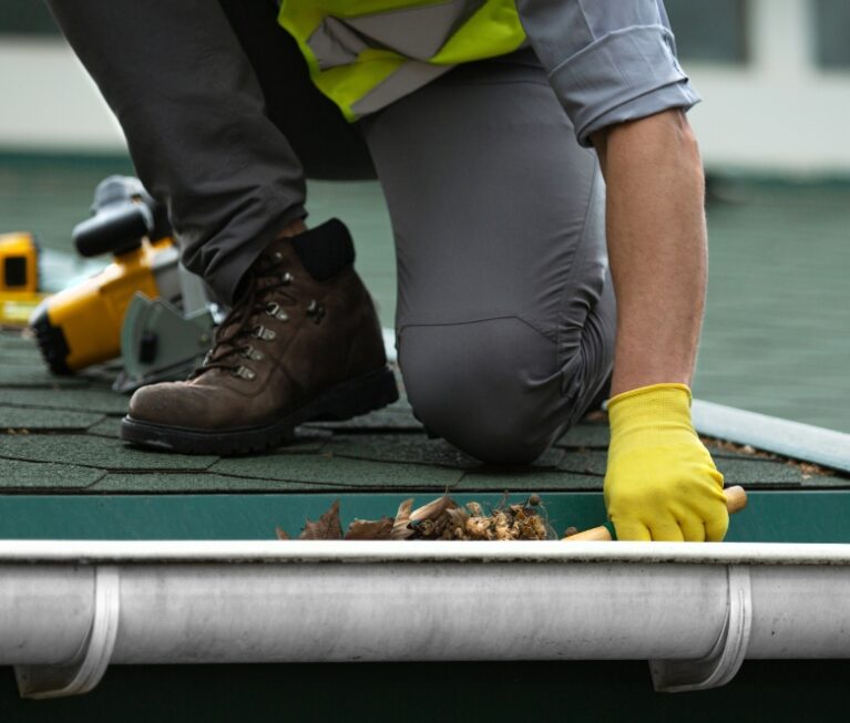 Gutter cleaning service performed by AJM Soft Wash Plus technician