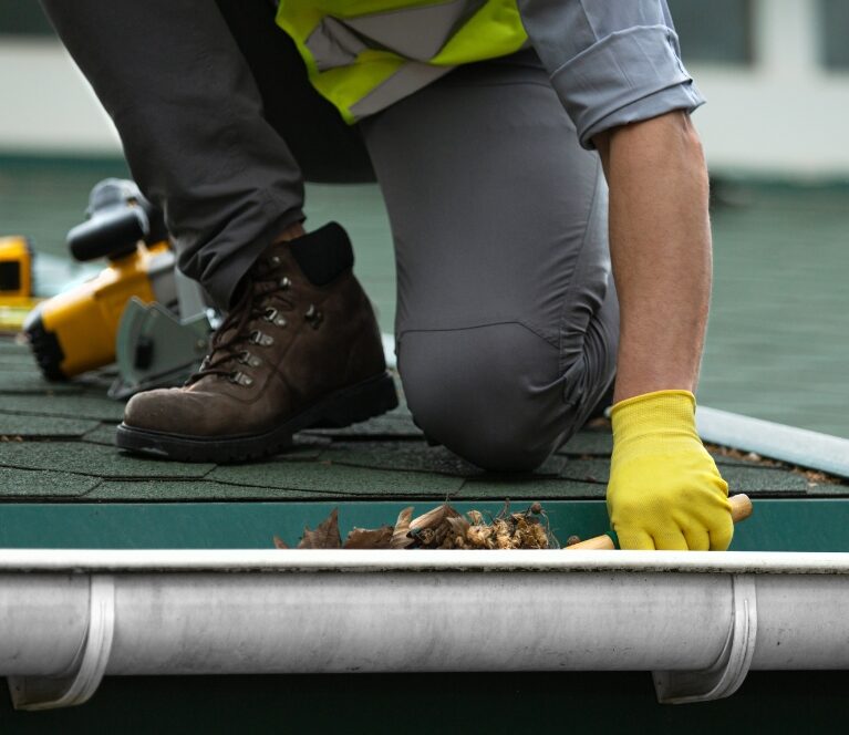 Gutter cleaning service performed by AJM Soft Wash Plus technician